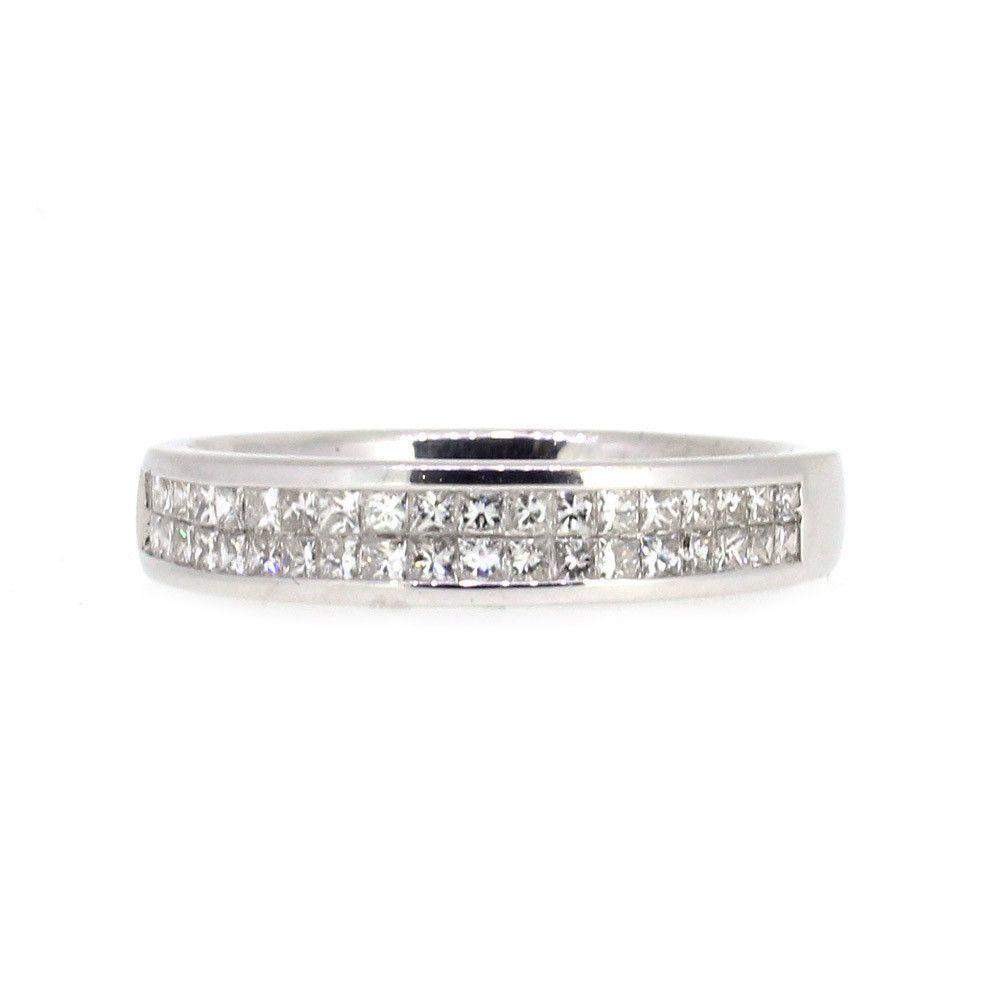 Silver ring with two rows of squarecut diamonds on a white background