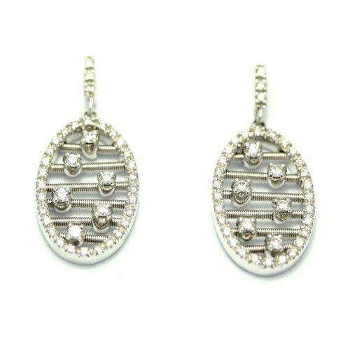 Oval silver earrings with intricate wire design and gems