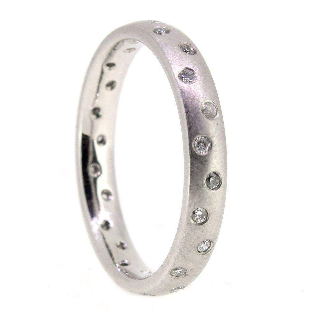 Closeup of a silver engagement ring with a round diamond center
